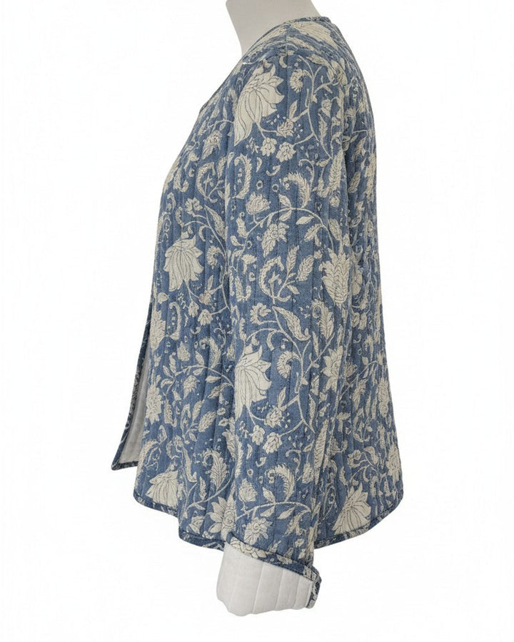 A women's long-sleeve jacket featuring a blue and white floral pattern. Quilted, lightweight  and has pockets